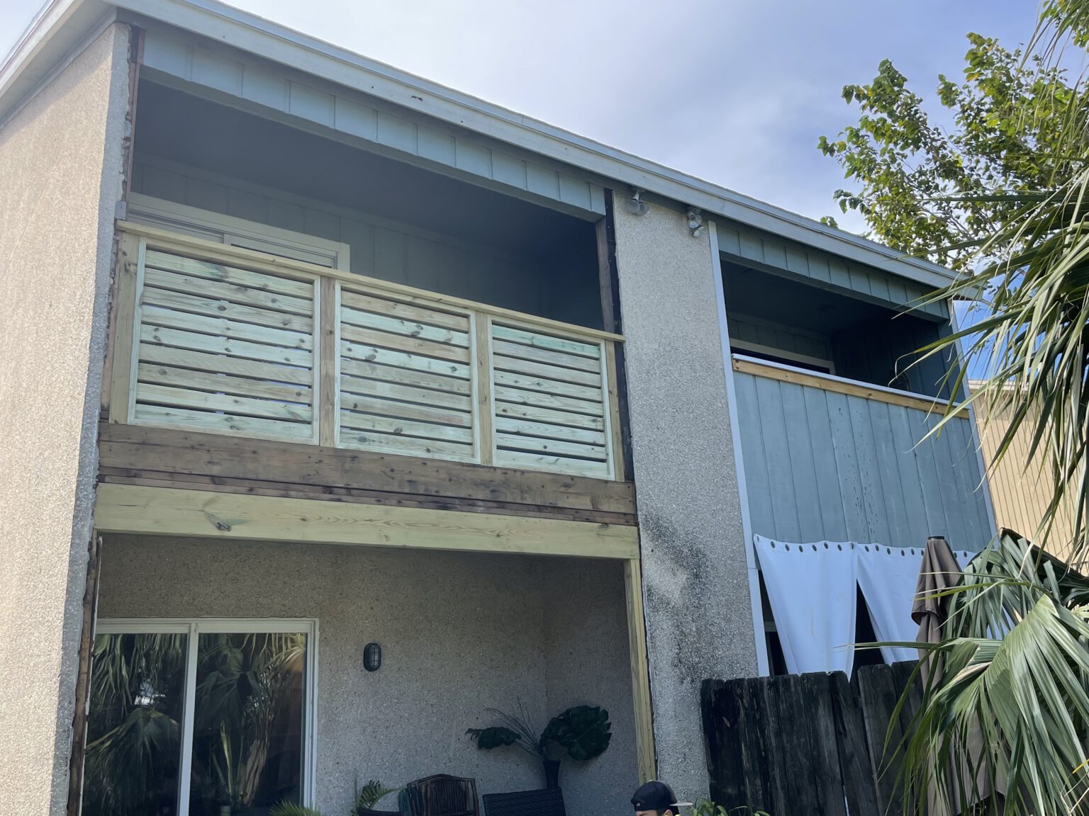 Two story coastal home with rebuilt balcony framing