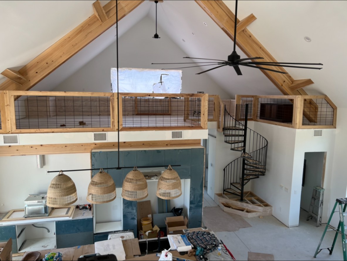 Timber truss and loft rail inside a finished building