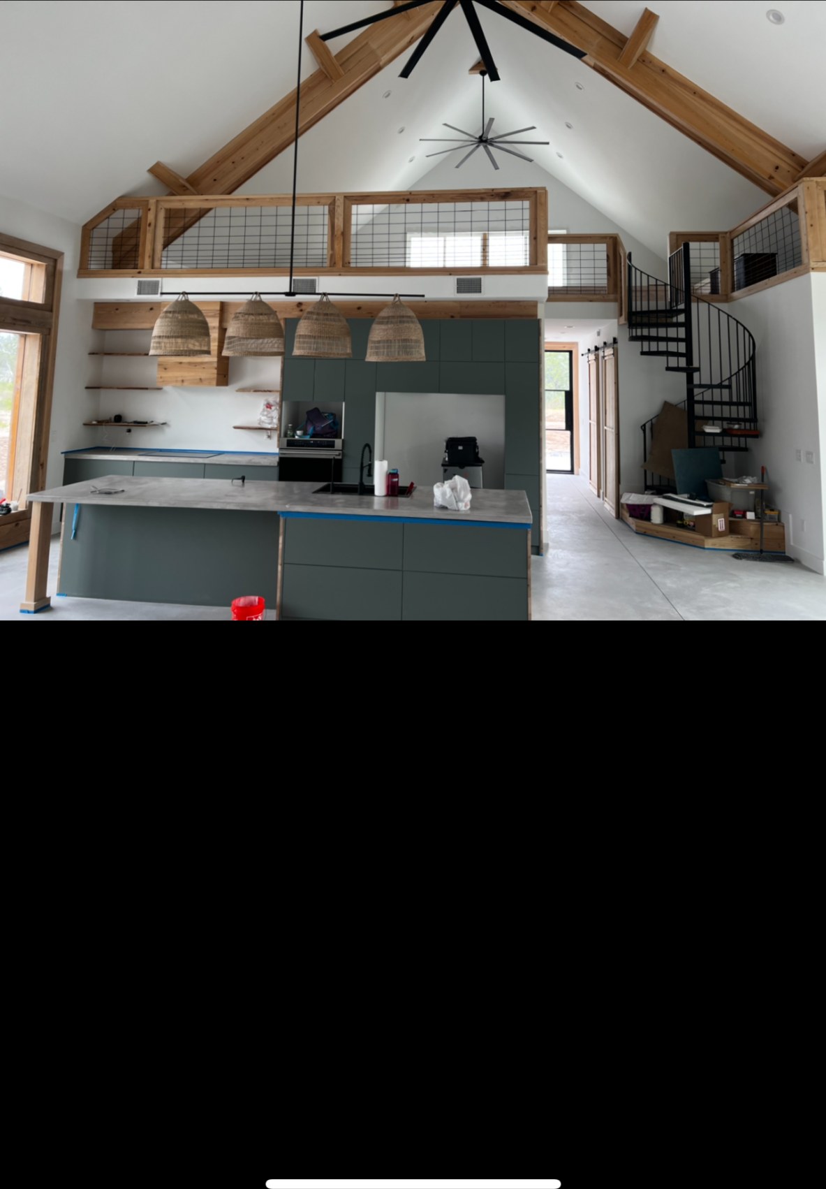 Loft kitchen under timber trusses